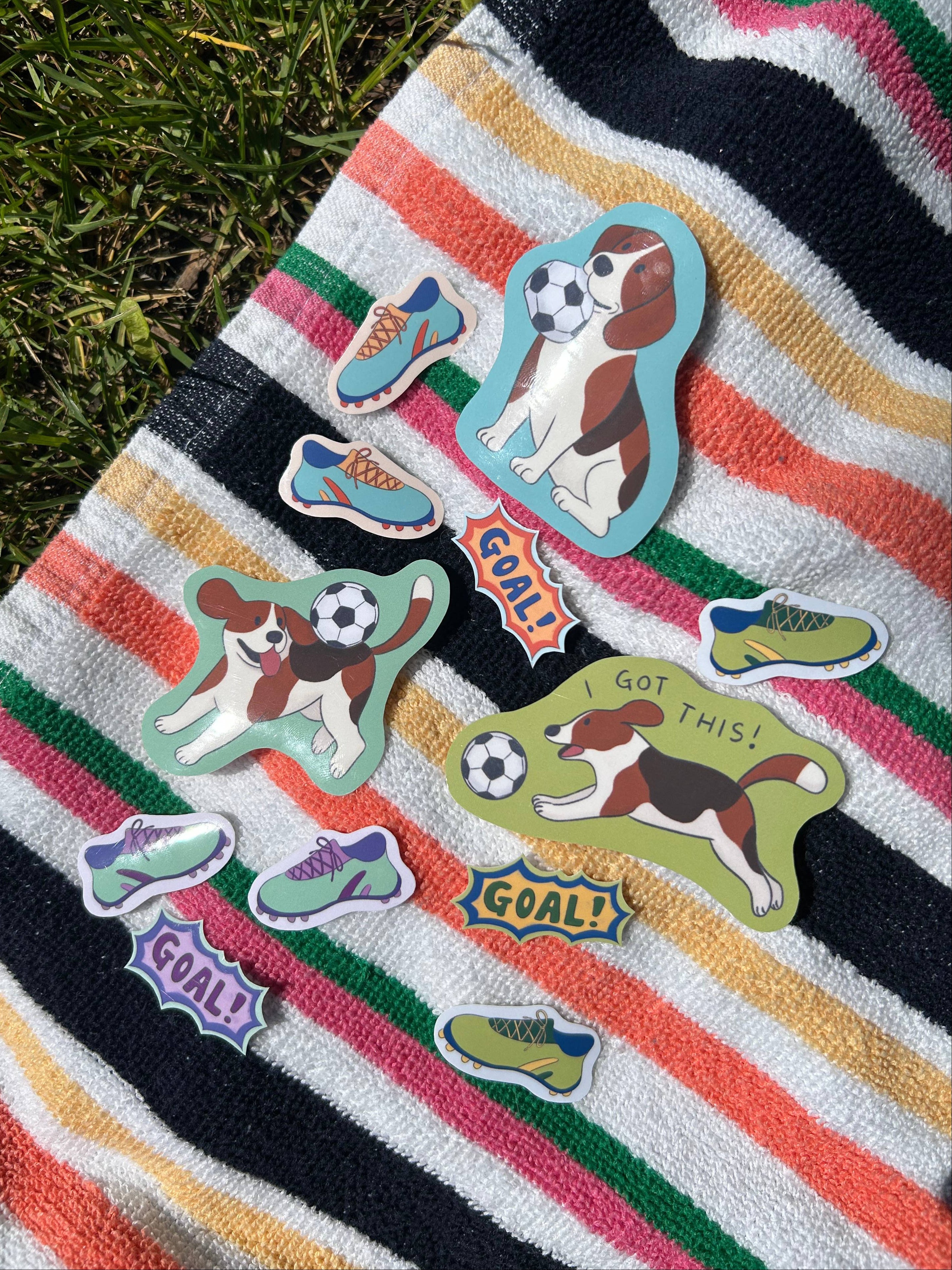 Striped towel with dog-themed stickers on grass