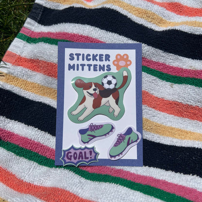 sticker of dog playing football with 'Sticker Mitten' branding on a striped towel