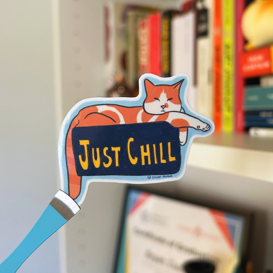 Cat-shaped sign with 'Just Chill' text on a bookshelf background